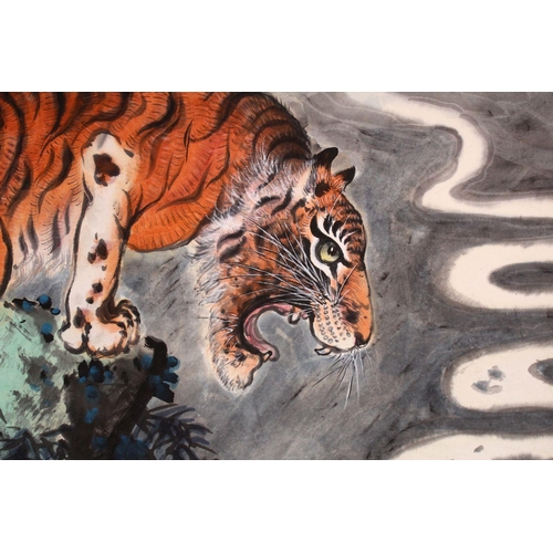 531 - A GOOD 20TH CENTURY CHINESE SCROLL PAINTING, depicting a growling tiger standing on a rocky outcrop ... 