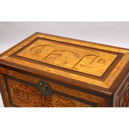 538 - A GOOD 20TH CENTURY CHINESE CARVED CAMPHORWOOD CHEST, the top and sides well carved with figures in ... 