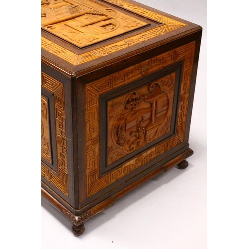 538 - A GOOD 20TH CENTURY CHINESE CARVED CAMPHORWOOD CHEST, the top and sides well carved with figures in ... 