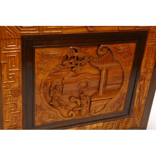 538 - A GOOD 20TH CENTURY CHINESE CARVED CAMPHORWOOD CHEST, the top and sides well carved with figures in ... 