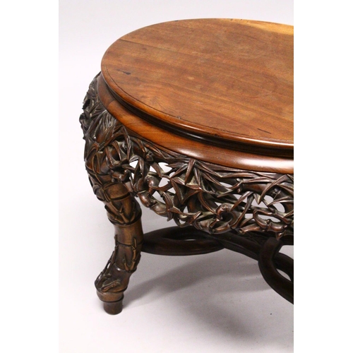 539 - A LATE 19TH CENTURY CHINESE HARDWOOD OVAL TABLE, plain top, supported on pierced and carved frieze o... 