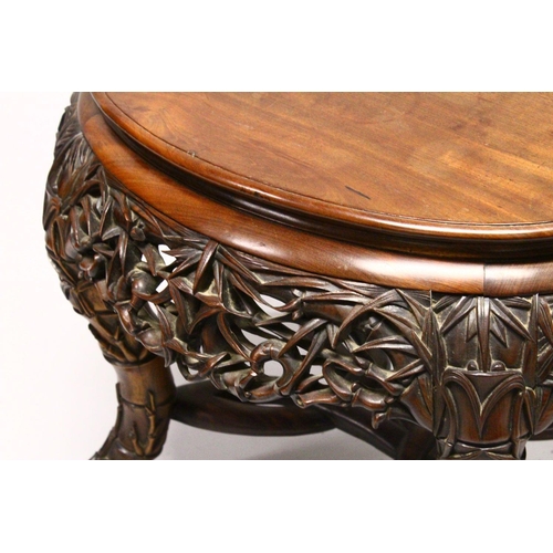 539 - A LATE 19TH CENTURY CHINESE HARDWOOD OVAL TABLE, plain top, supported on pierced and carved frieze o... 