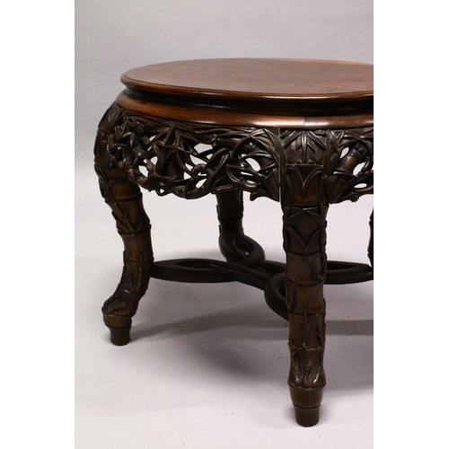 539 - A LATE 19TH CENTURY CHINESE HARDWOOD OVAL TABLE, plain top, supported on pierced and carved frieze o... 