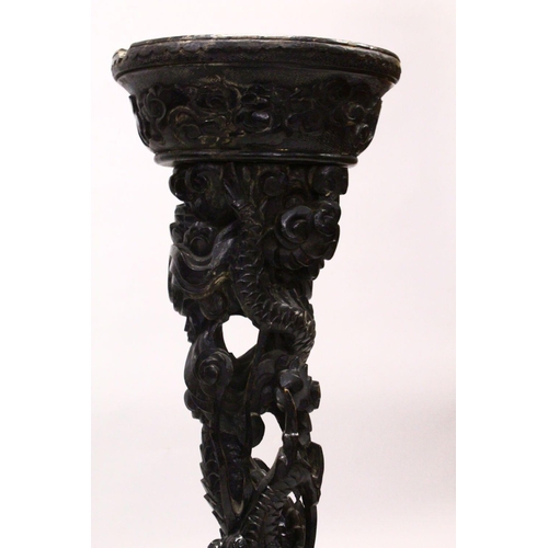 541 - A PAIR OF 19TH CENTURY CARVED WOODEN DRAGON STANDS, the centres carved with intertwined dragons down... 