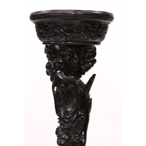 541 - A PAIR OF 19TH CENTURY CARVED WOODEN DRAGON STANDS, the centres carved with intertwined dragons down... 