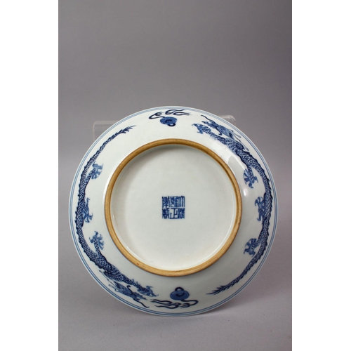 57 - A CHINESE BLUE & WHITE PORCELAIN YONGZHENG STYLE DRAGON DISH, decorated with a central dragon, the e... 