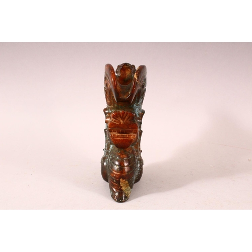 58 - A 20TH CENTURY CHINESE ARCHAIC STYLE CARVED HARDSTONE EWER, the body carved as a dragon, the handle ... 