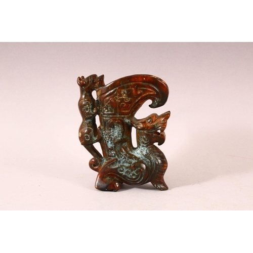 58 - A 20TH CENTURY CHINESE ARCHAIC STYLE CARVED HARDSTONE EWER, the body carved as a dragon, the handle ... 