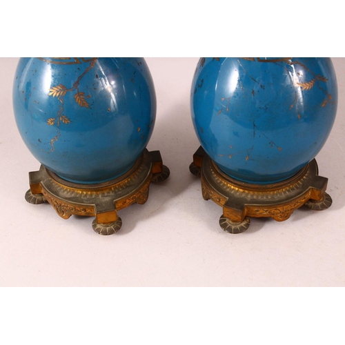 59 - A PAIR OF 19TH CENTURY CHINESE PORCELAIN BOTTLE VASES / LAMP BASES, the ground with gilded decoratio... 