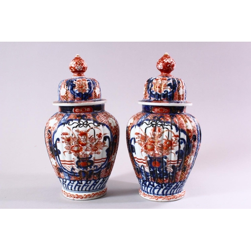 6 - A PAIR OF JAPANESE MEIJI PERIOD IMARI PORCELAIN VASES & COVERS, with panel decoration depicting disp... 