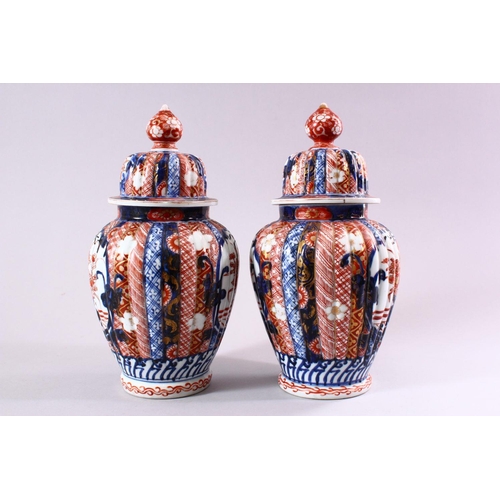 6 - A PAIR OF JAPANESE MEIJI PERIOD IMARI PORCELAIN VASES & COVERS, with panel decoration depicting disp... 