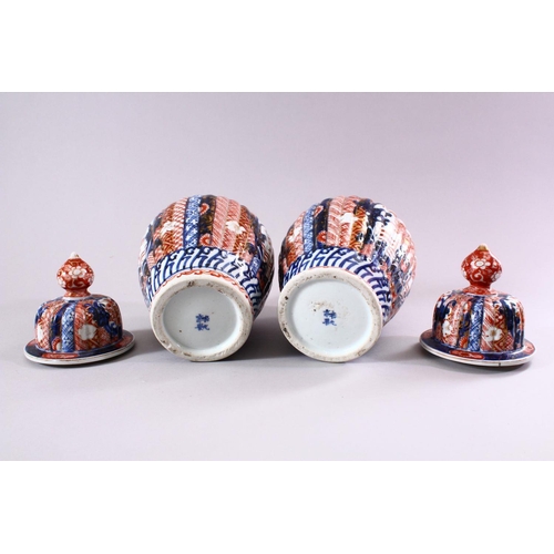 6 - A PAIR OF JAPANESE MEIJI PERIOD IMARI PORCELAIN VASES & COVERS, with panel decoration depicting disp... 