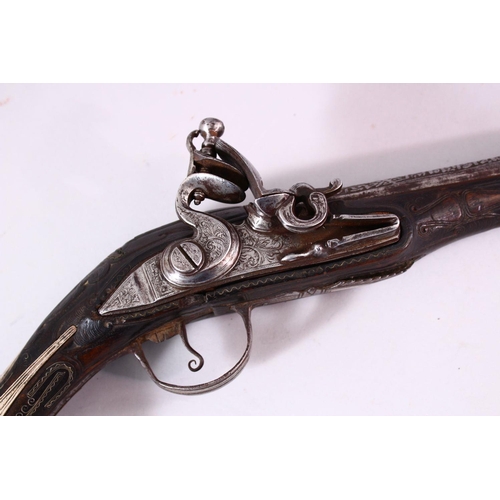 604 - A GOOD 18TH CENTURY PERSIAN FLINTLOCK PISTOL, with engraved lockplate and barrel, silver inlaid grip... 