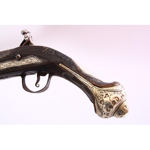 604 - A GOOD 18TH CENTURY PERSIAN FLINTLOCK PISTOL, with engraved lockplate and barrel, silver inlaid grip... 