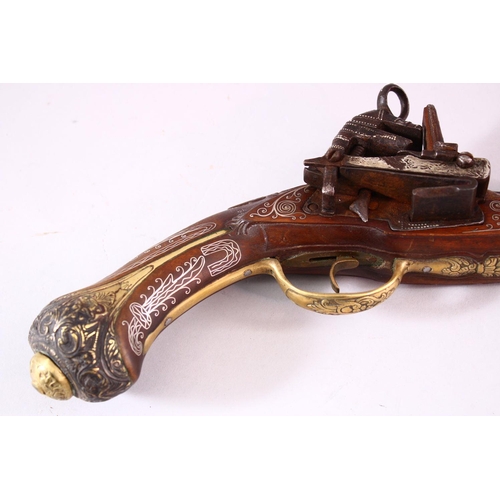 605 - AN 18TH CENTURY INDIAN FLINTLOCK PISTOL, with silver inlaid barrel, well carved wooden stock with si... 