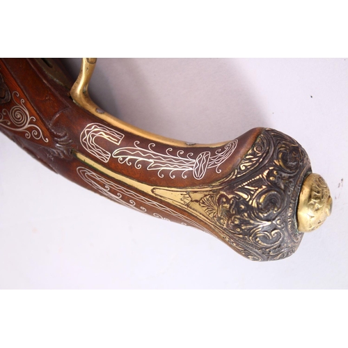 605 - AN 18TH CENTURY INDIAN FLINTLOCK PISTOL, with silver inlaid barrel, well carved wooden stock with si... 