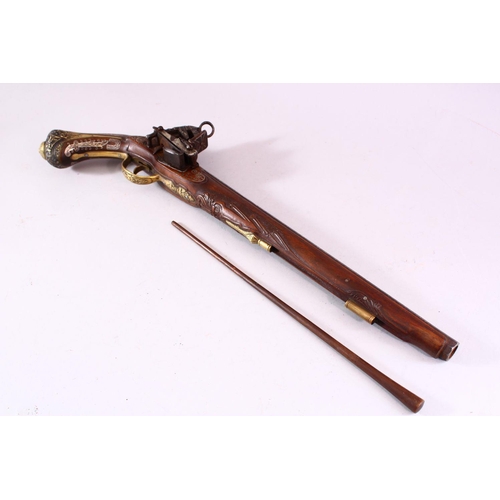 605 - AN 18TH CENTURY INDIAN FLINTLOCK PISTOL, with silver inlaid barrel, well carved wooden stock with si... 