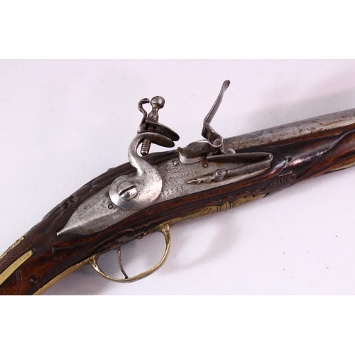 609 - AN 18TH CENTURY ANGLO INDIAN FLINTLOCK PISTOL, engraved barrel, carved stock with wire inlaid decora... 