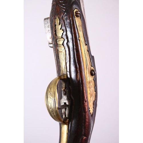 609 - AN 18TH CENTURY ANGLO INDIAN FLINTLOCK PISTOL, engraved barrel, carved stock with wire inlaid decora... 