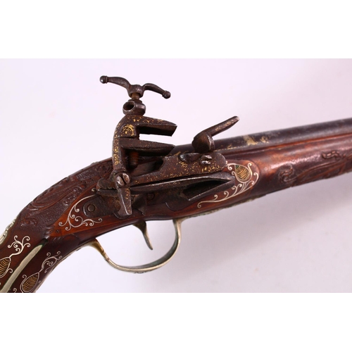 610 - AN 18TH CENTURY INDIAN FLINTLOCK PISTOL, with gold inlaid barrel, carved stone, profusely inlaid wit... 