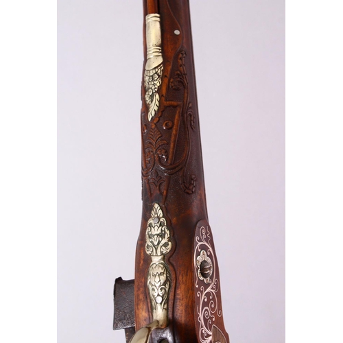 610 - AN 18TH CENTURY INDIAN FLINTLOCK PISTOL, with gold inlaid barrel, carved stone, profusely inlaid wit... 