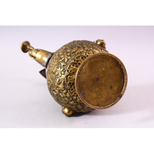 612 - A 19TH CENTURY INDIAN MOULDED BRASS JUG, with moulded elephant head spout and dog handle, the body w... 