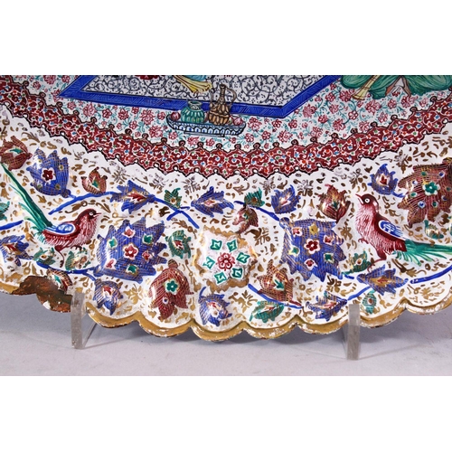 640 - AN INDIAN ENAMELLED COPPER DISH of lobed oval form, the centre painted with a courting couple and mu... 