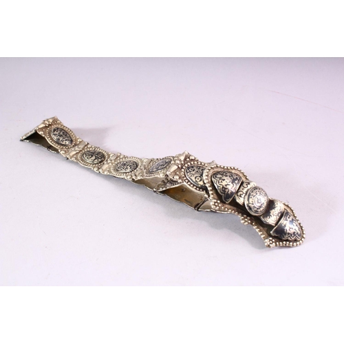 642 - A RUSSIAN NIELLO DECORATED WHITE METAL BELT, consisting of an ornate buckle and fourteen oval panels... 