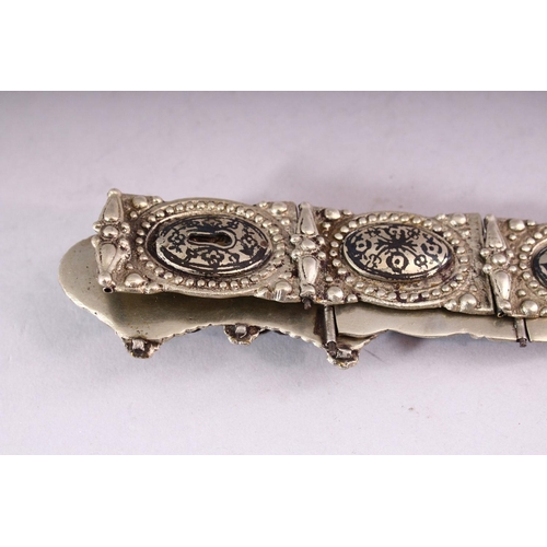 642 - A RUSSIAN NIELLO DECORATED WHITE METAL BELT, consisting of an ornate buckle and fourteen oval panels... 