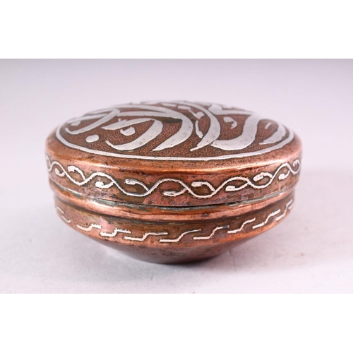 647 - AN ISLAMIC CIRCULAR COPPER BOX AND COVER, the cover with silver inlaid calligraphy, 10cm diameter.