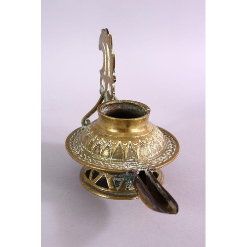 654 - AN UNUSUAL EARLY ISLAMIC POSSIBLY ANDALUSIAN SPANISH BRASS OIL LAMP, with moulded decoration, 17cm w... 