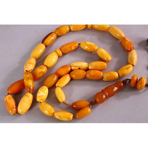 659 - A COLLECTION OF TWO ISLAMIC POSSIBLY OTTOMAN AMBER PRAYER BEADS AND ANOTHER POSSIBLY CHERRY AMBER BA... 