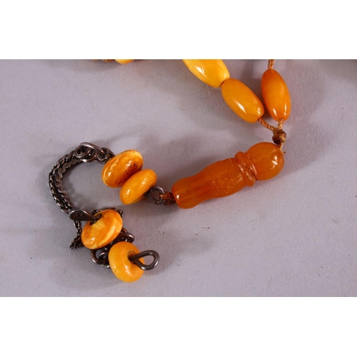 659 - A COLLECTION OF TWO ISLAMIC POSSIBLY OTTOMAN AMBER PRAYER BEADS AND ANOTHER POSSIBLY CHERRY AMBER BA... 