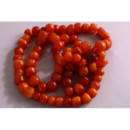 659 - A COLLECTION OF TWO ISLAMIC POSSIBLY OTTOMAN AMBER PRAYER BEADS AND ANOTHER POSSIBLY CHERRY AMBER BA... 