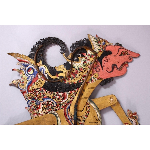 664 - A LARGE 19TH CENTURY INDONESIAN SHADOW PUPPET WITH RHINO HORN STICKS, 73cm.