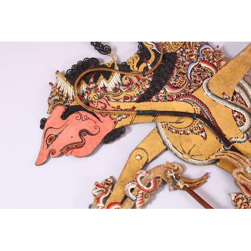 664 - A LARGE 19TH CENTURY INDONESIAN SHADOW PUPPET WITH RHINO HORN STICKS, 73cm.