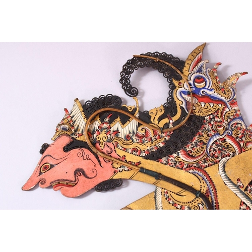 664 - A LARGE 19TH CENTURY INDONESIAN SHADOW PUPPET WITH RHINO HORN STICKS, 73cm.