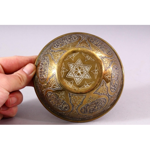 677 - A SMALL ISLAMIC CIRCULAR BRASS BOWL with silver inlaid and engraved decoration, 13cm diameter.