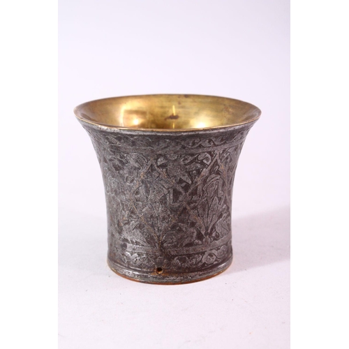 680 - A SMALL BRASS AND ENGRAVED STEEL BEAKER SHAPED VESSEL, the exterior engraved with figures, 7.5cm dia... 