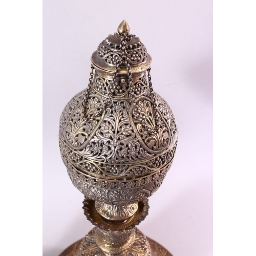 683 - A FINE 19TH CENTURY INDIAN SILVER AND GILT HUQQA BASE, pierced with floral decoration, with two late... 