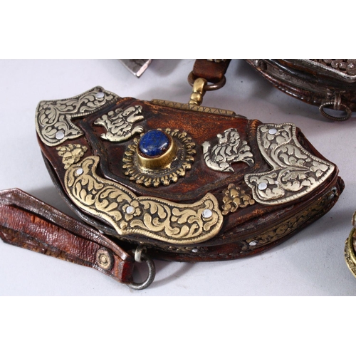 693 - FIVE 19TH CENTURY LEATHER BETEL NUT POUCHES with ornate embossed and applied decoration.