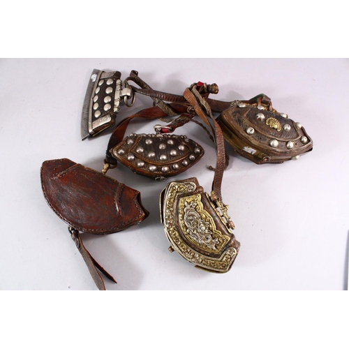 693 - FIVE 19TH CENTURY LEATHER BETEL NUT POUCHES with ornate embossed and applied decoration.