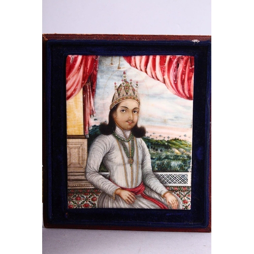 695 - A 19TH CENTURY INDIAN PORTRAIT MINIATURE OF A SEATED GENTLEMAN, painted on ivory in a leather foldin... 