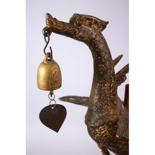 697 - AN INDONESIAN CAST AND GILDED TEMPLE BELL IN THE FORM OF A BIRD standing with outspread wings and be... 