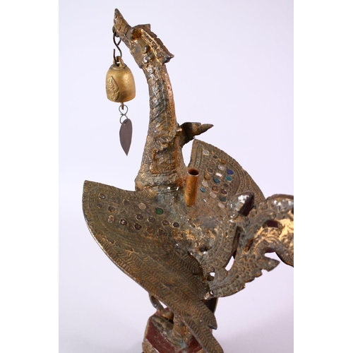 697 - AN INDONESIAN CAST AND GILDED TEMPLE BELL IN THE FORM OF A BIRD standing with outspread wings and be... 