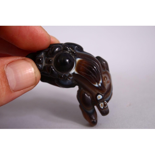 70 - A CHINESE CARVED AGATE FIGURE OF A MYTHICAL LION DOG, 5cm.