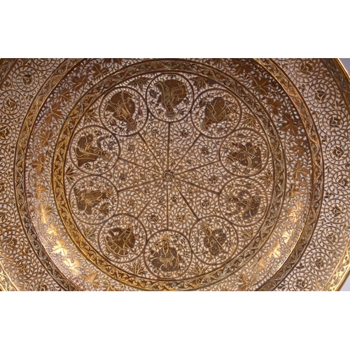 700 - A GOOD INDIAN PIERCED GILDED WHITE METAL CIRCULAR DISH, 23cm diameter.