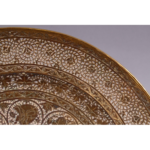 700 - A GOOD INDIAN PIERCED GILDED WHITE METAL CIRCULAR DISH, 23cm diameter.