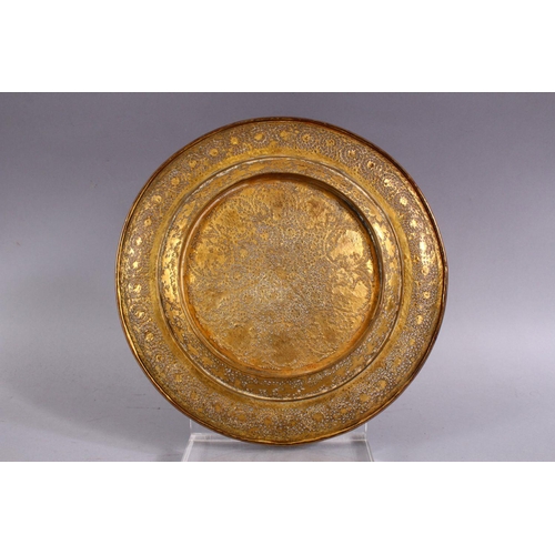 700 - A GOOD INDIAN PIERCED GILDED WHITE METAL CIRCULAR DISH, 23cm diameter.