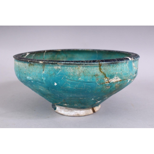 701 - AN EARLY PERSIAN OTTOMAN TURQUOISE GLAZED POTTERY BOWL (repairs and restoration), 19cm diameter.